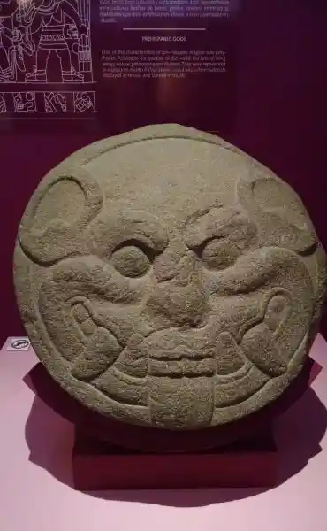Smiling face with fangs carved on a stone